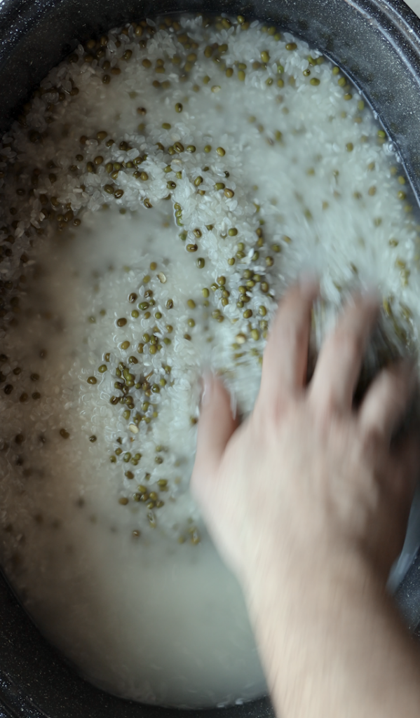 Calrose rice from Ariana sweets and mung beans being rinsed thoroughly then being drained for Shola